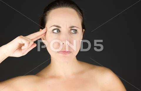 Photograph: Model isolated on plain background hand gesture gun #43187437