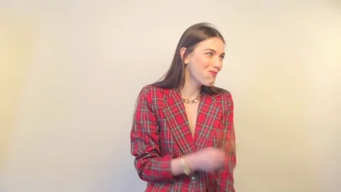 Model in jacket eats cookies and smiles Stock Footage 73368416