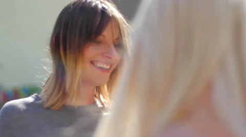 Model joking with stylist during open air dressing up Stock Footage 59733297