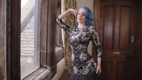 Model leaning seductively by window Stock Footage 109488567