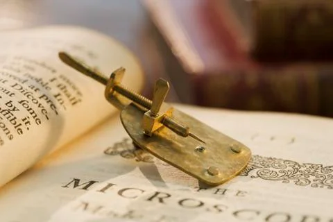 Model of Leeuwenhoek microscope on book Stock Photos