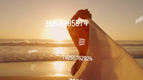 Model lifting shawl on shore starting moving data over her draping showing Stock Footage 333540257
