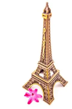 Model of little Eiffel Tower with a pink flower Stock Photos