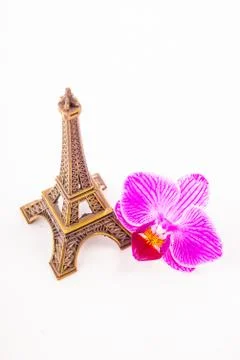 Model of little Eiffel Tower with a pink flower Stock Photos