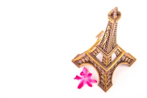 Model of little Eiffel Tower with a pink flower Stock Photos