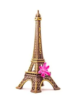 Model of little Eiffel Tower with a pink flower Stock Photos