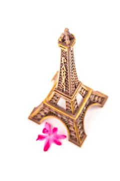Model of little Eiffel Tower with a pink flower Stock Photos