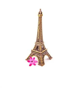 Model of little Eiffel Tower with a pink flower Stock Photos
