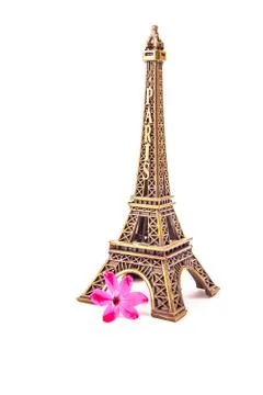 Model of little Eiffel Tower with a pink flower Stock Photos