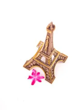 Model of little Eiffel Tower with a pink flower Stock Photos