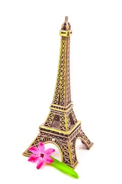 Model of little Eiffel Tower with a pink flower Stock Photos