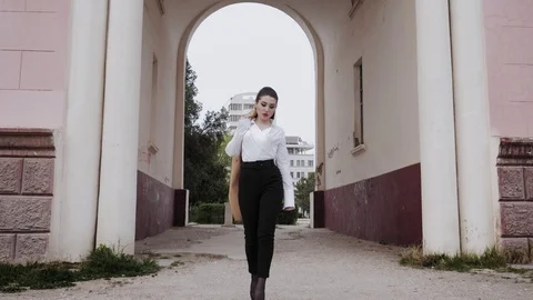 Model with long brown ponytail confidently goes straight Stock Footage 107919103