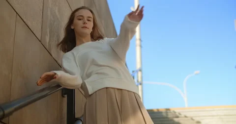 Model with long legs and dressed in mini are posing in slow motion in public Video stock 165810369