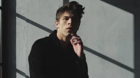 Model look guy posing to the camera touching face Stock Footage 60840908