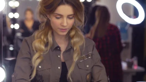 Model looking at her reflection in the mirror Stock Footage 88711882