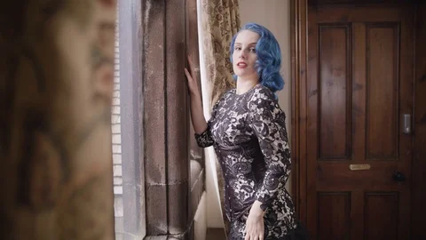 Model looking out of window seductively Stock Footage 109488565