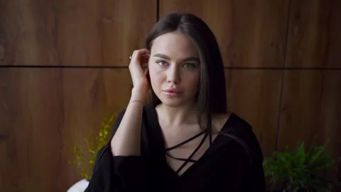 The model looks into the camera and sexually corrects her hairstyle. Stock Footage 256158259