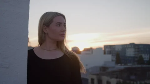 Model Looks out on Rooftop Video stock 270400230