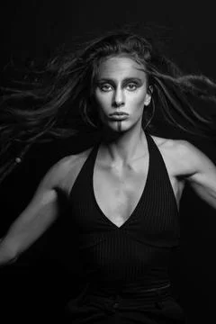 Model with make-up and hair with dreadlocks jumping in air and looking at c.. Stock Photos