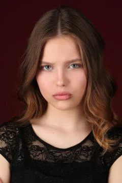 Model with makeup. Close up. Dark red background Stock Photos