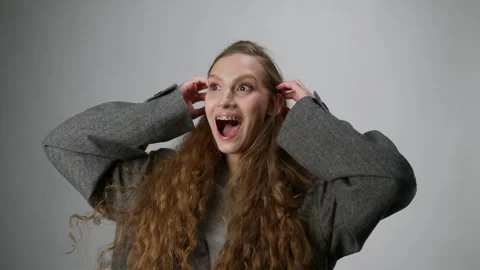 The model is making faces at the camera. Installing a bracket system for a woman Stock Footage 279731971
