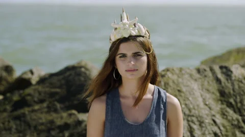 Model with Mermaid Sea Shell Crown at Beach Stares at Camera, Medium Stock Footage 134962966