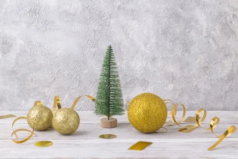 Model of miniature christmas tree with golden christmas decor Stock Photos
