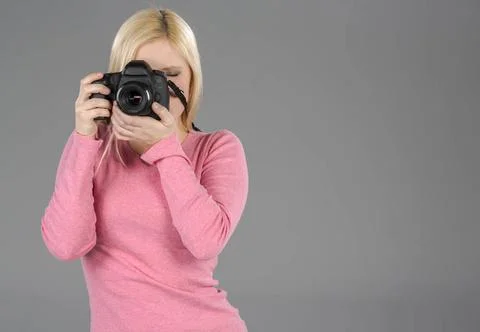  Model With Modern Camera Blonde model holding a camera in a studio enviro... Stock Photos