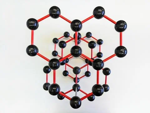 Model of molecule with red and black balls on white surface Stock Photos