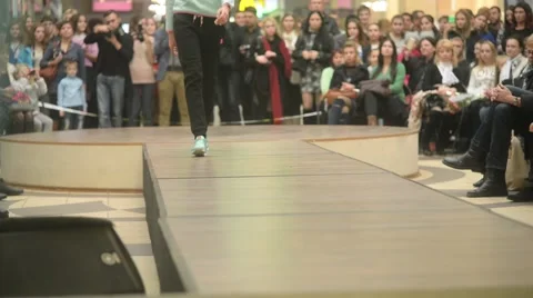 Model parades down catwalk podium - the audience watching a fashion show Stock-Footage 56730697