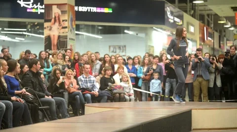 Model parades down catwalk podium - the audience watching a fashion show Stock-Footage 56730718