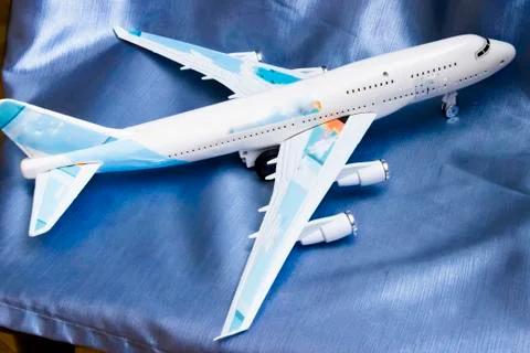 Model of passenger plane on blue background Stock Photos