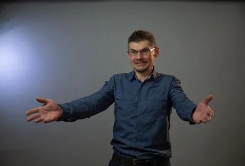 Model performs emotion of confused man with raised hands Stock Photos