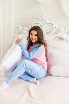 Model in pink pyjamas in bed Stock Photos