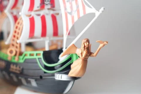 Model pirate ship from plastic, on a gray background, Foto stock