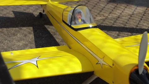 Model Plane With Yellow Colors And Figurine Sitting In It Stock Footage 130676683