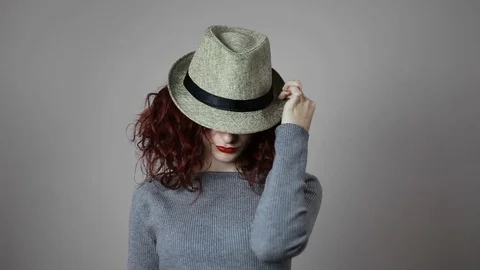 A model is playing with her favorite hat and with her red hair Stock Footage 82040182