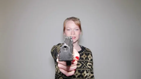 Model playing with pistol Stock Footage 73539524