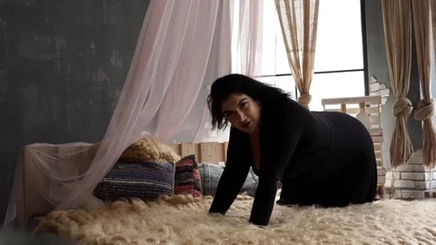 Model plus size with big cheeks and black hair lies almost naked on the bed Stock Footage 106065494