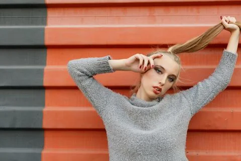 Model pointing upwards in studio and looking at camera Stock Photos