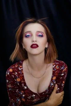 The model poses for the camera on a dark background Stock Photos