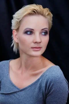 The model poses for the camera on a dark background Stock Photos