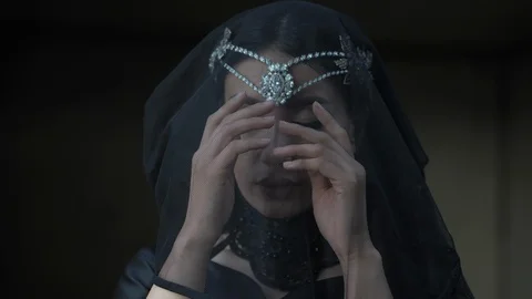 Model poses for camera running hands on black veil closeup Stock Footage 126271029