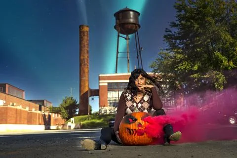 Model Poses With A Jack O Lantern With Smoke For The Halloween holiday in the Stock Photos