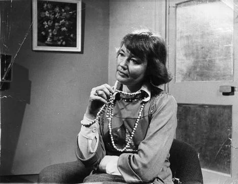 A Model Poses As A Job Interviewee. She Fiddles With The Beads Around Her Neck W Stock Photos
