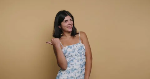 Model poses in studio against yellow background and shows playful expressio.. Stock Footage 326792912