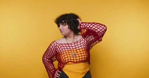 Model poses in studio with bright yellow background during photo session at.. Vídeo Stock 328247949