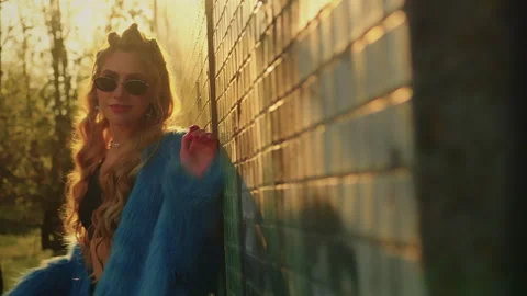 Model posing against the wall. in a blue fur coat Stock Footage 302541467