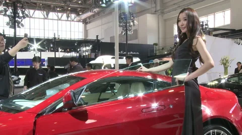 Model posing with Aston Martin car, Beijing Stock Footage 56586959