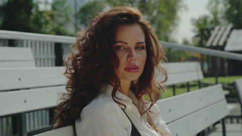 Model posing for camera. Lovely coquettish brunette woman, winking bitting lips. Stock Footage 161554337